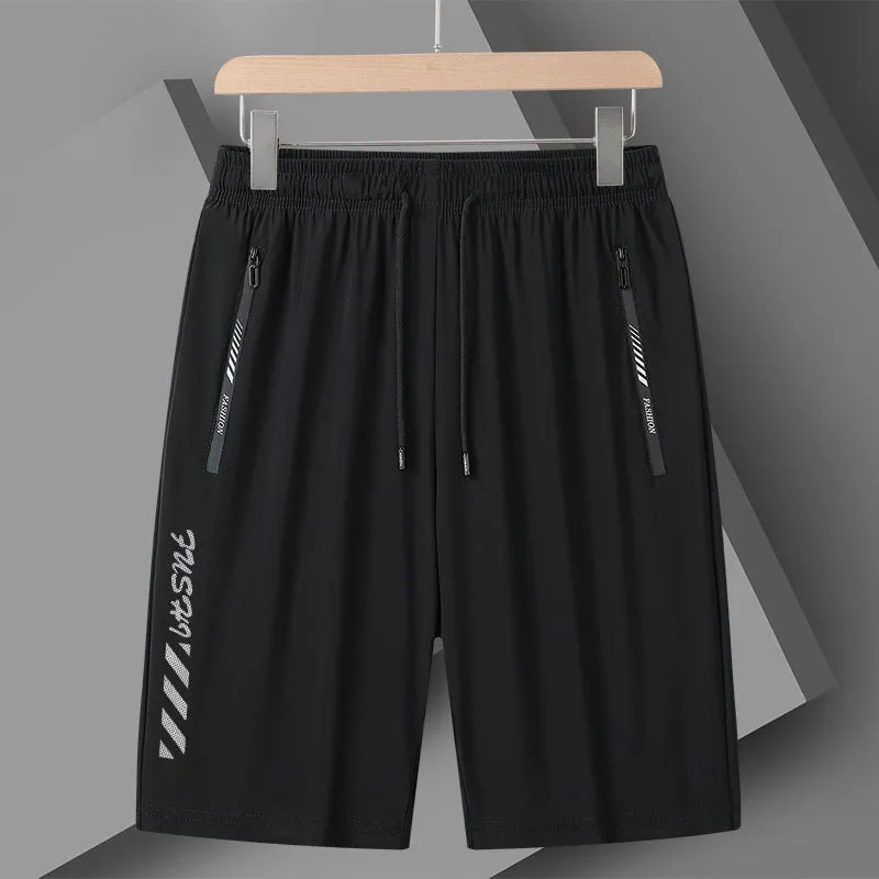 Man wearing black loose-fit quick-drying nylon sports shorts with an elastic waistband.