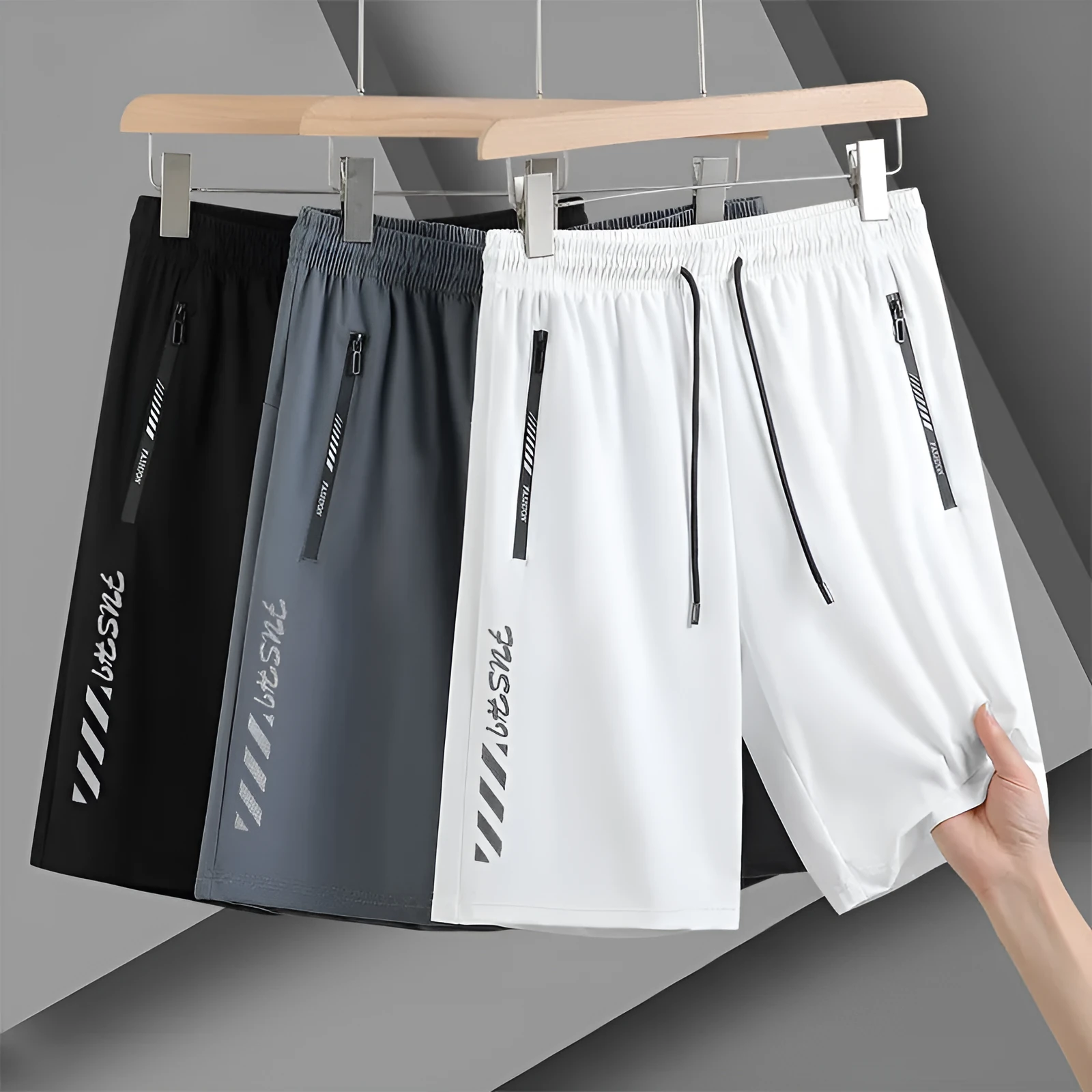 Man wearing black loose-fit quick-drying nylon sports shorts with an elastic waistband.