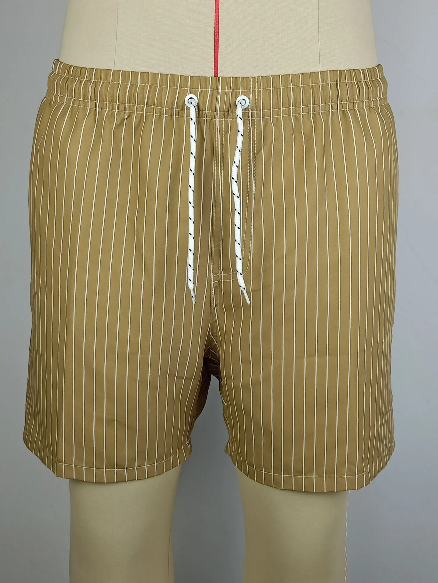 Polyester fibre striped beach shorts with straight leg openings and triangle lining in multiple colours