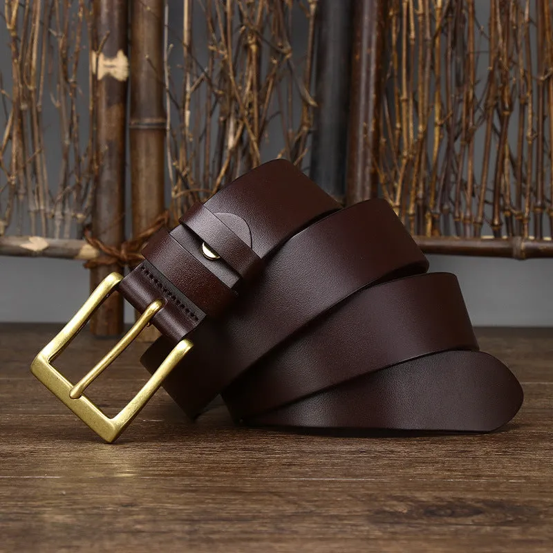 Men's brown leather belt with copper pin buckle on a plain background showing glossy first layer cowhide finish