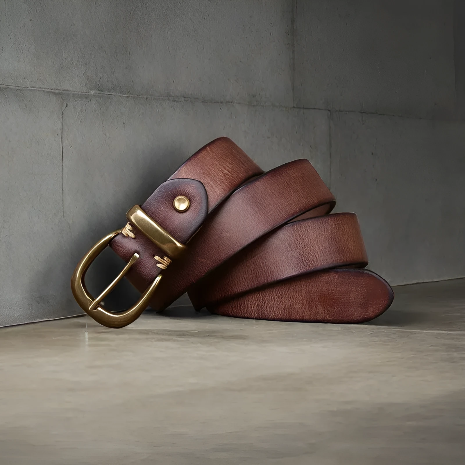 Men's casual leather belt in black with copper buckle showing length adjustment holes