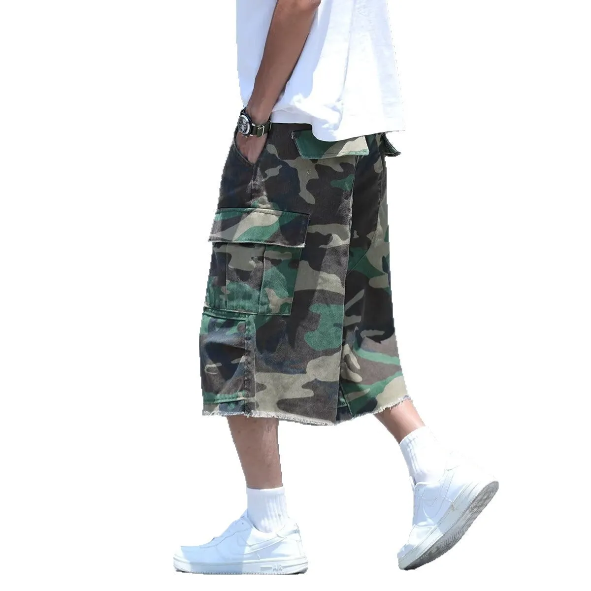 Man wearing loose, cropped camouflage shorts in a khaki colourway, showcasing the summer workwear style.