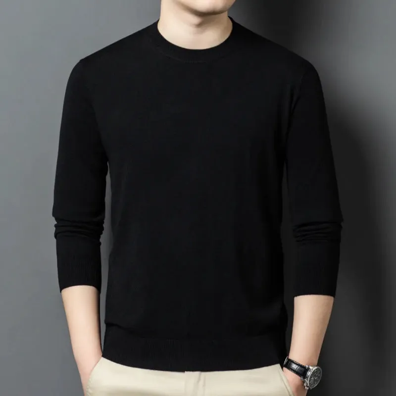 Man wearing a round neck grey wool and mulberry silk pullover sweater with long sleeves.