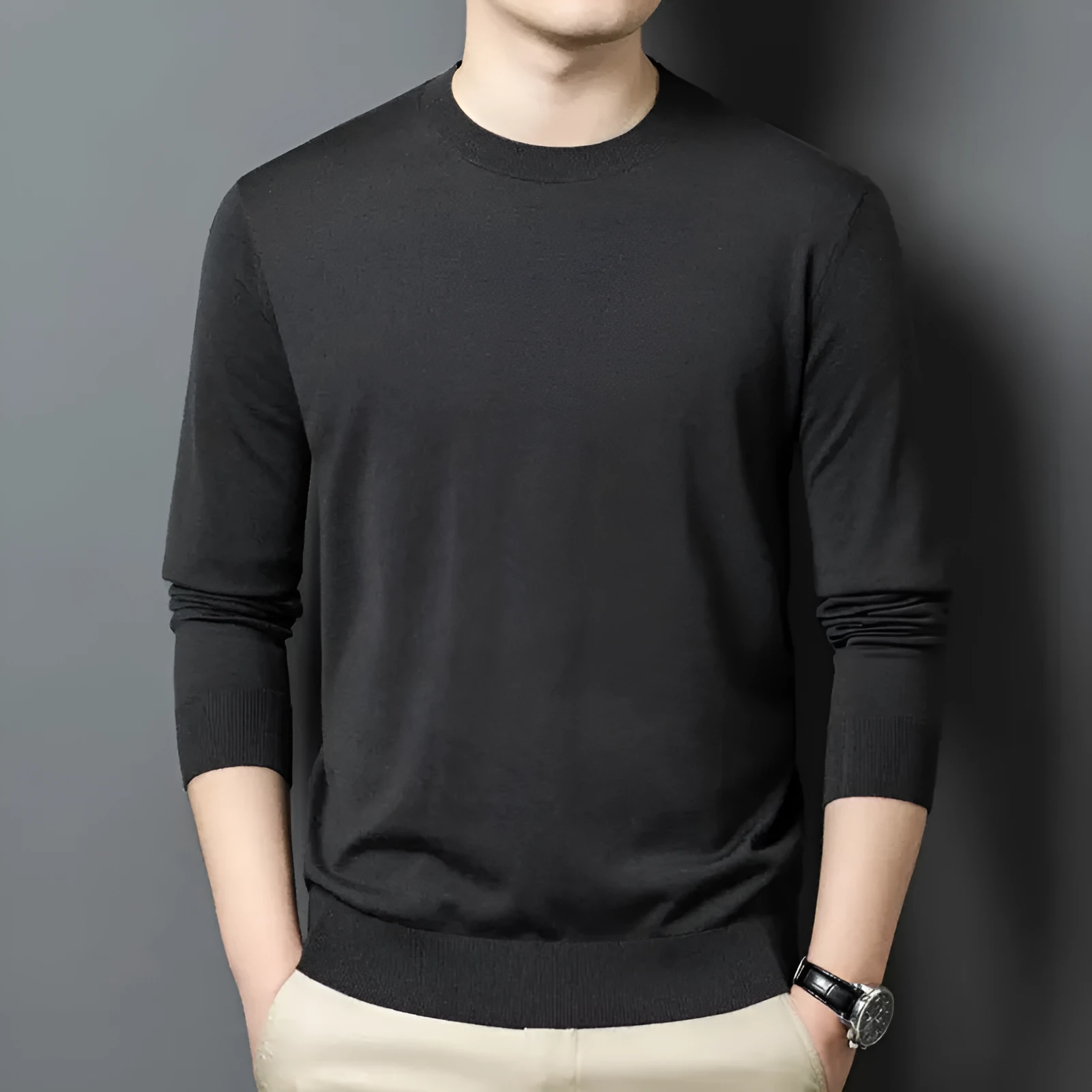 Man wearing a round neck grey wool and mulberry silk pullover sweater with long sleeves.