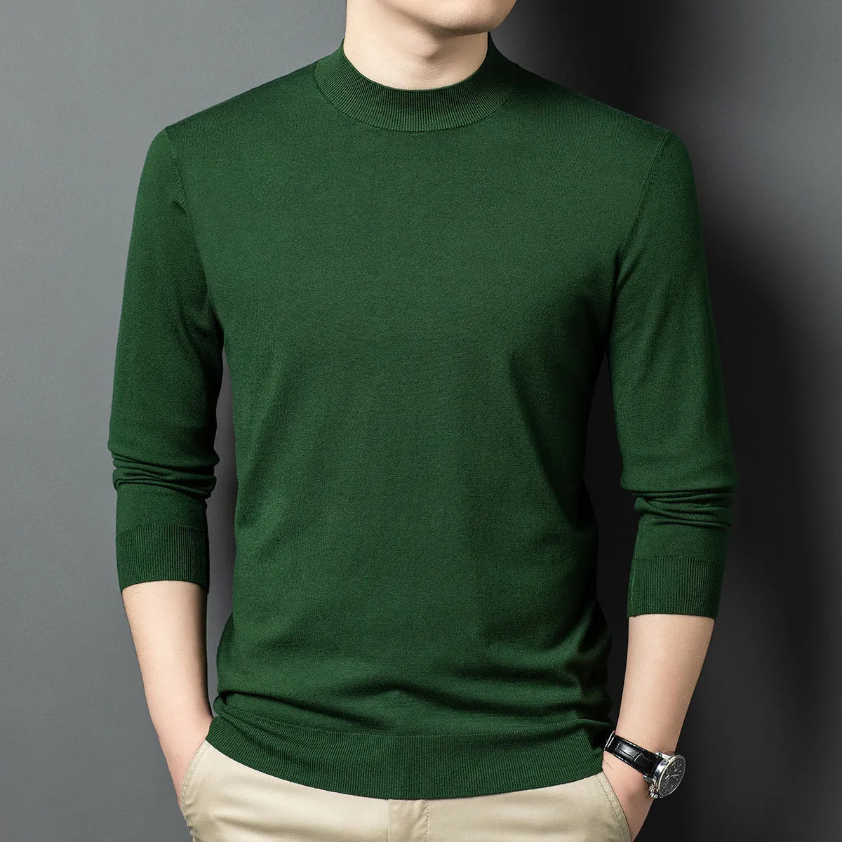 Man wearing a round neck grey wool and mulberry silk pullover sweater with long sleeves.
