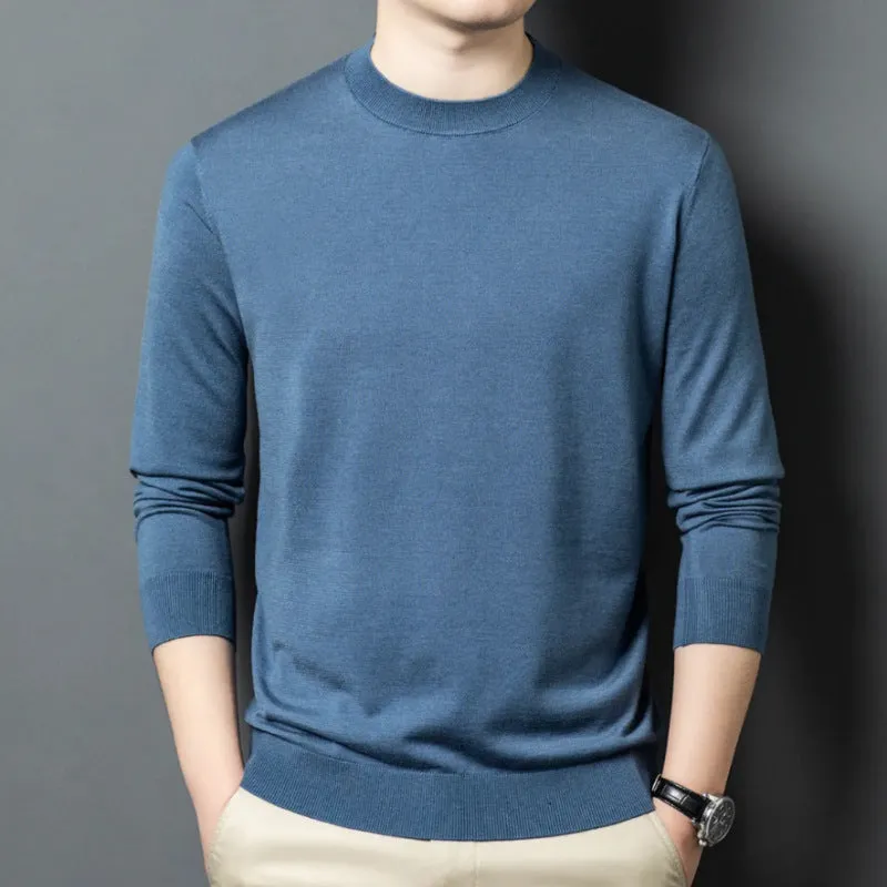Man wearing a round neck grey wool and mulberry silk pullover sweater with long sleeves.