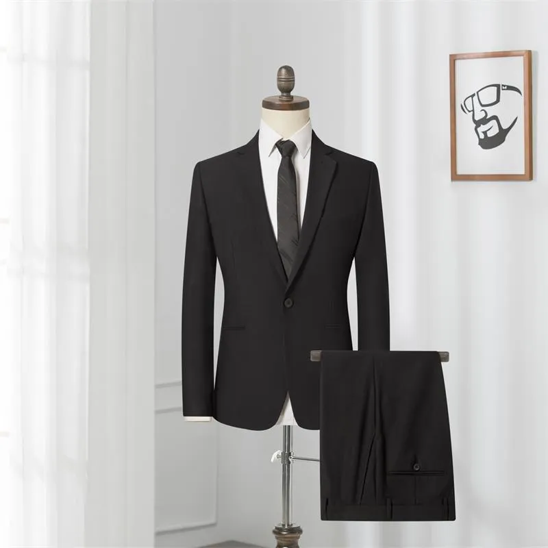 Men's black slim-fit one-button business suit with flat collar and rear slit on a hanger.
