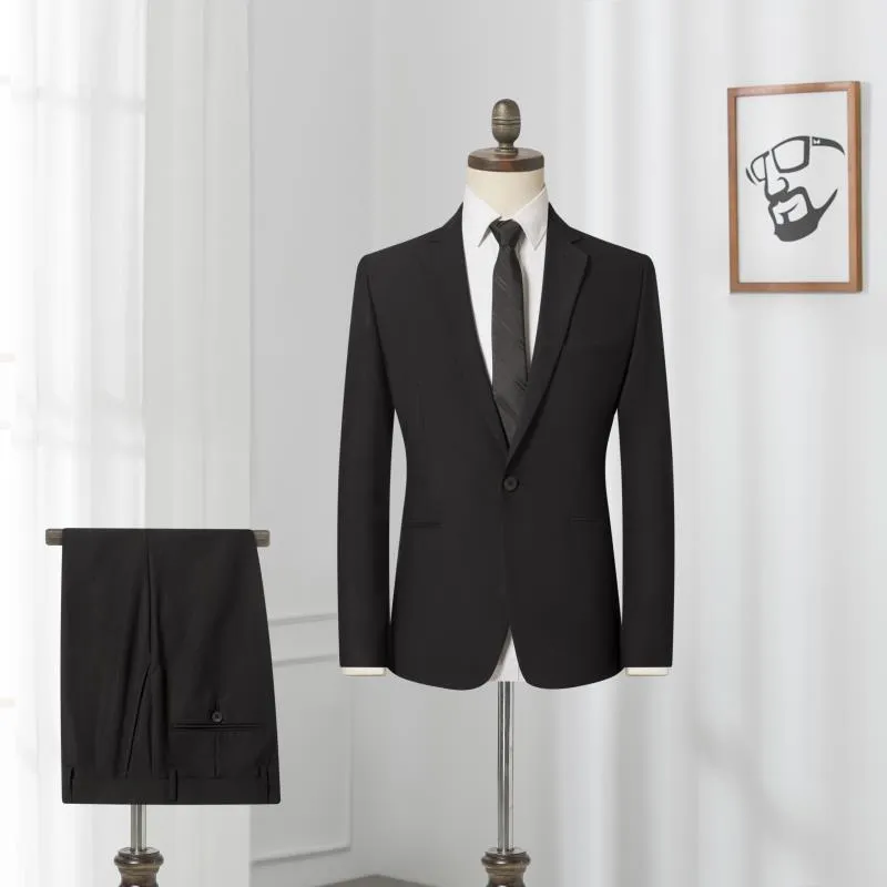 Men's black slim-fit one-button business suit with flat collar and rear slit on a hanger.