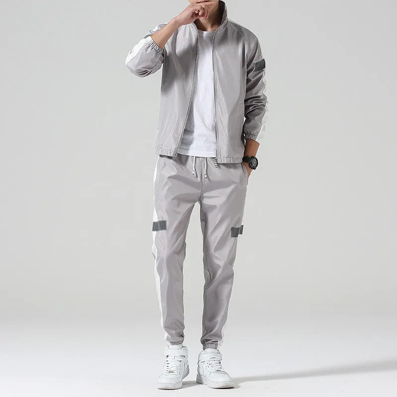 Reflective track suit in black polyester with reflective strips, front view