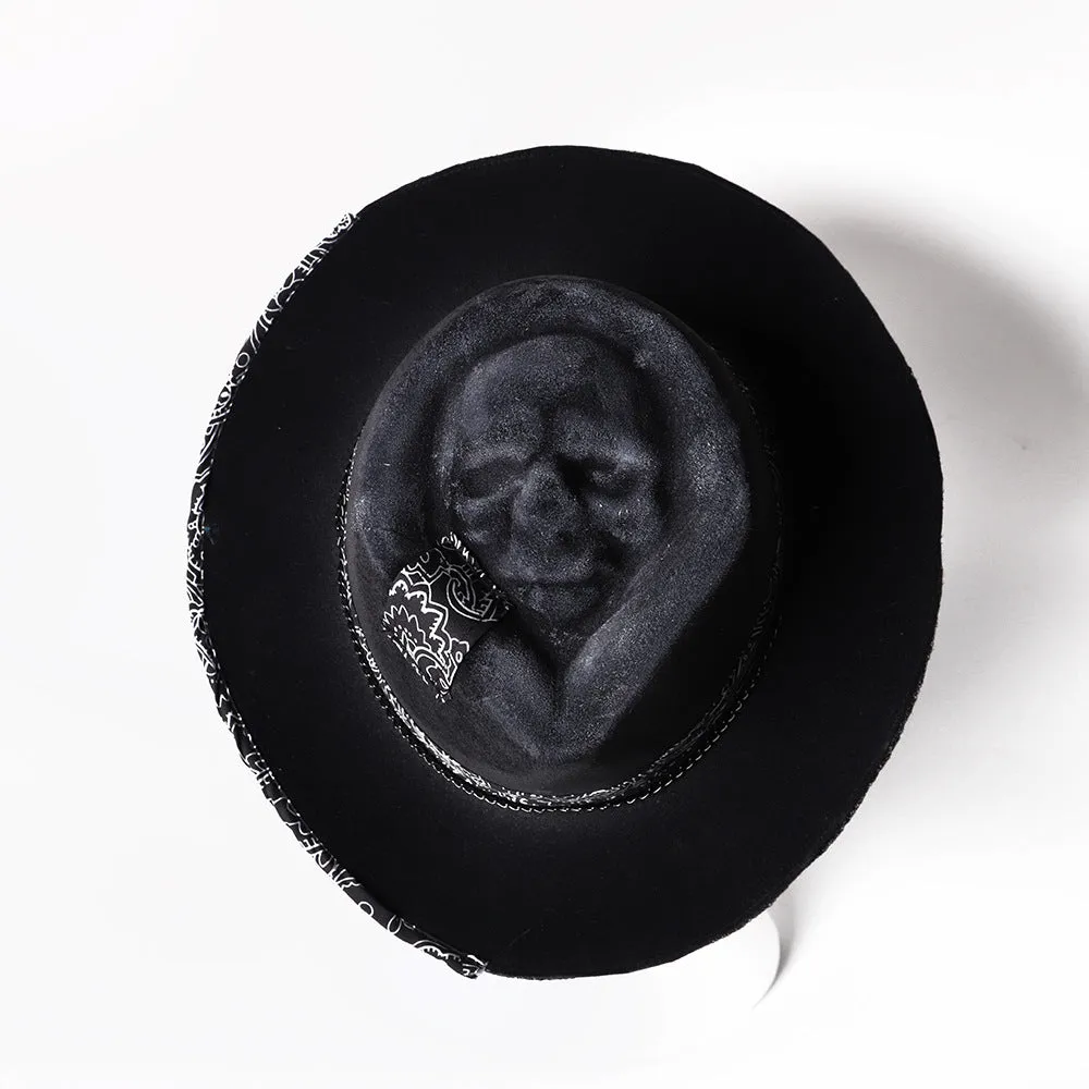 Handmade wool felt skull hat with a pointed conical crown on a neutral background.