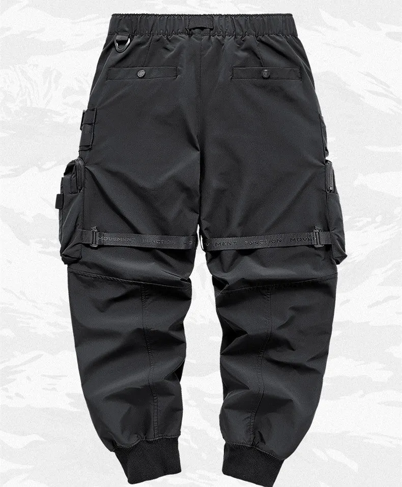 Men's black multi pocket cargo pants in polyester, loose fit, mid-waist style, on white background