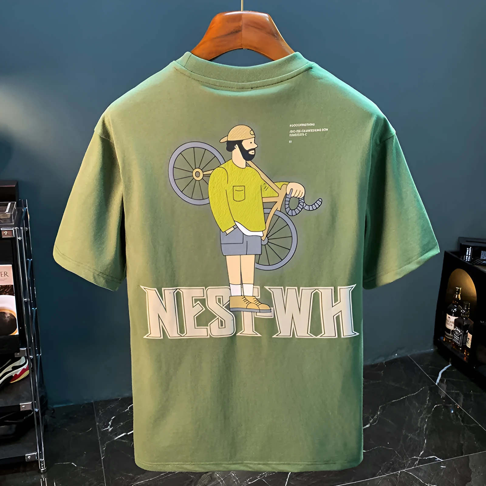 Green men's loose t-shirt with a literary graphic print on the front, short sleeves.
