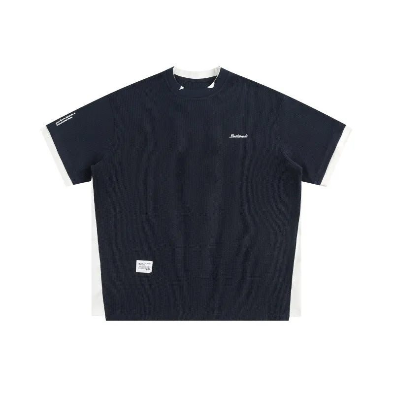 Retro loose waffle short-sleeved t-shirt with embroidered alphabet design in navy blue.