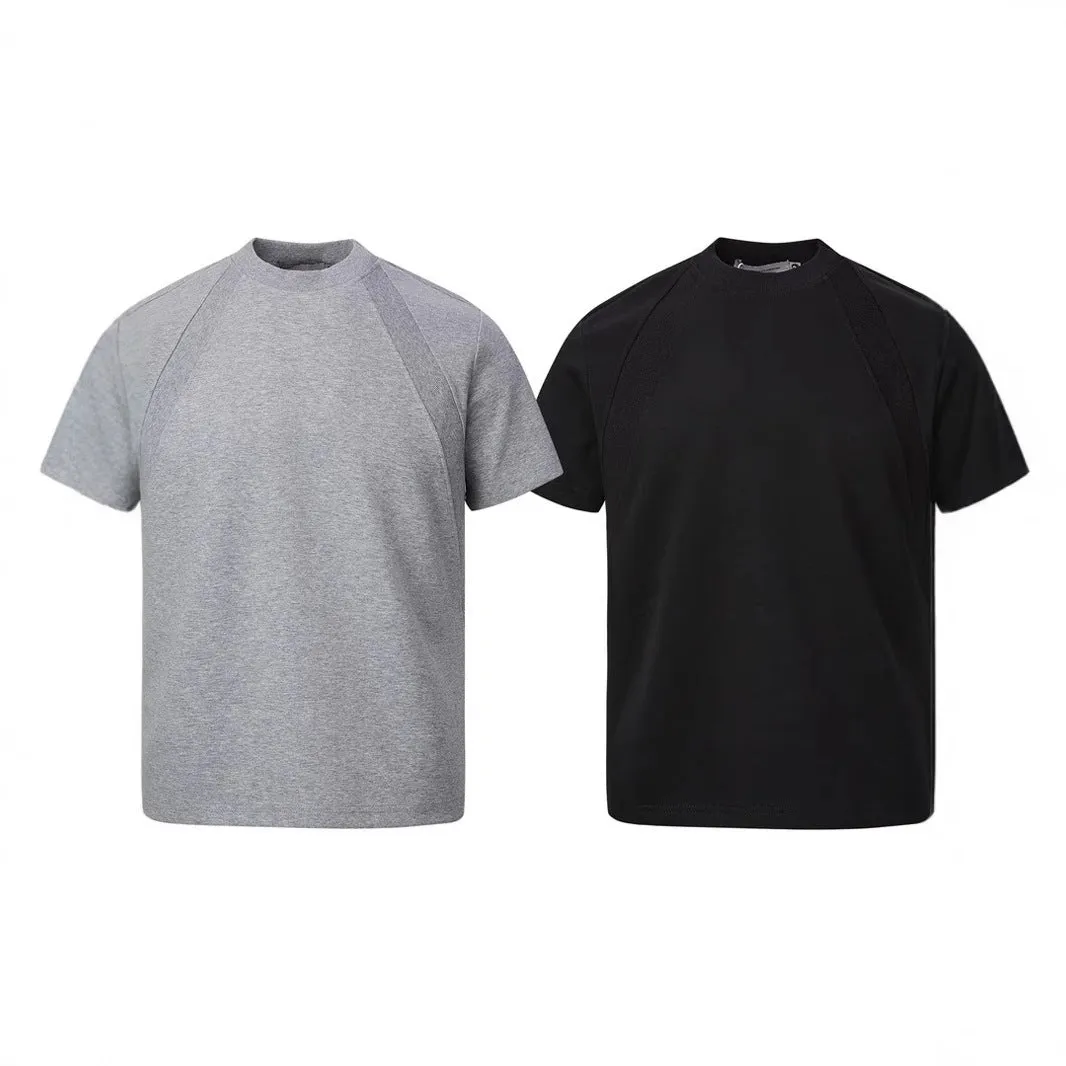 Men's loose fit short sleeve top in black with air layer stitching detail on a grey background.