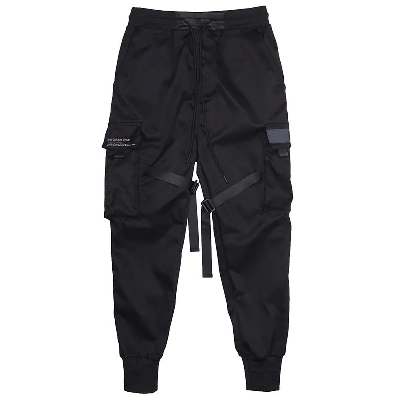 Black cotton cargo pants with tether closure, loose fit, ankle length, on a model