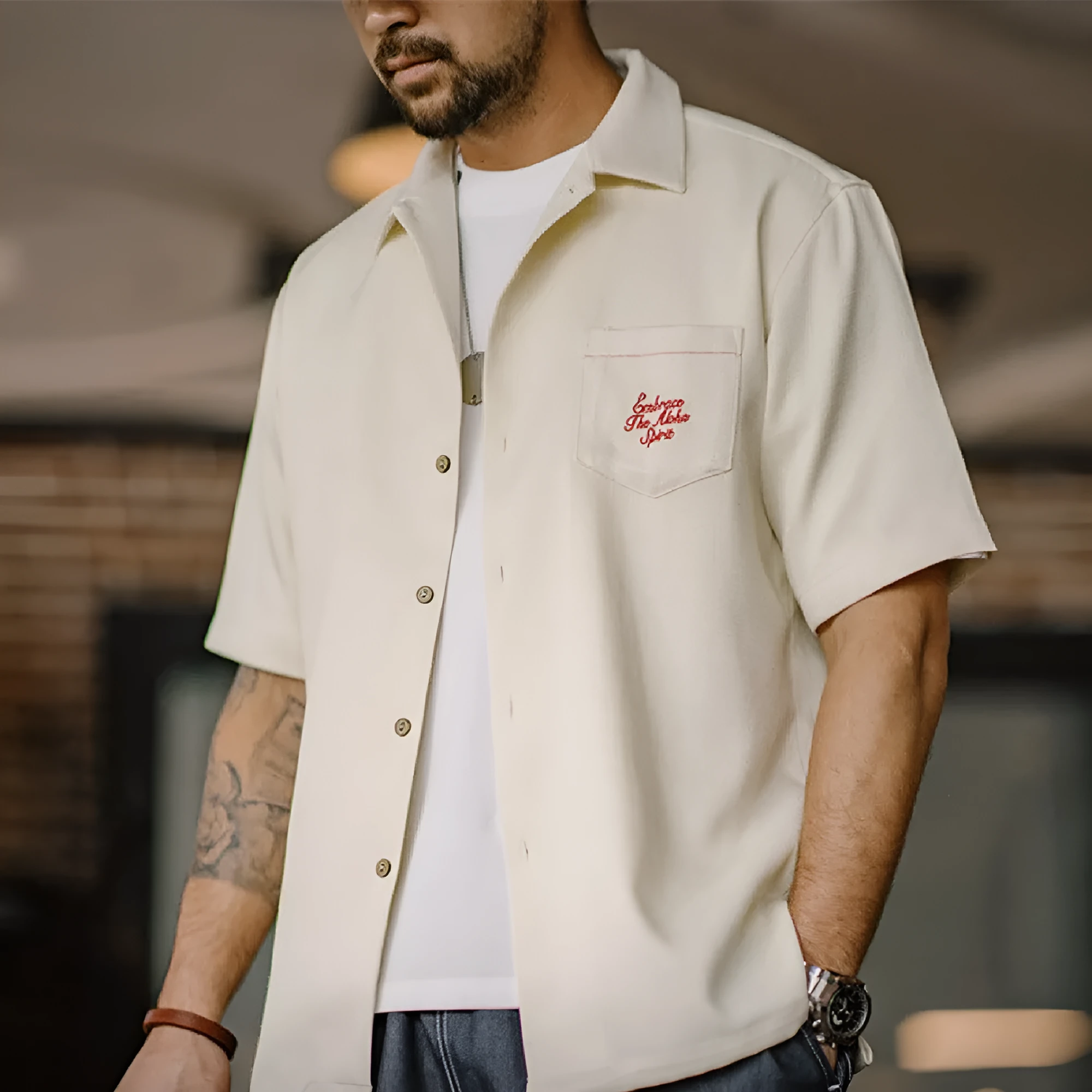 Light apricot men's shirt with bamboo pattern and Cuban collar shown on hanger