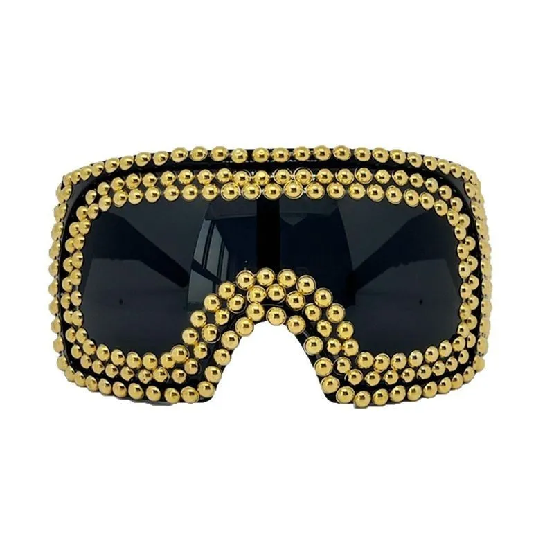 Men's punk style sunglasses with a large square frame and silver rivet details