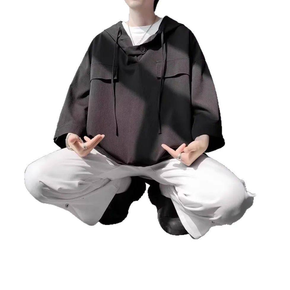 Man wearing a loose fit black hooded short sleeve T-shirt for summer.