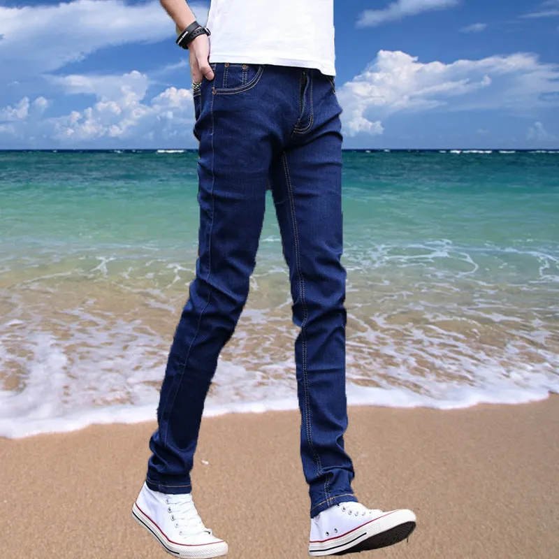Thin men's loose skinny casual jeans in pure black with low waist, cropped leg, small leg opening, and zip fly.