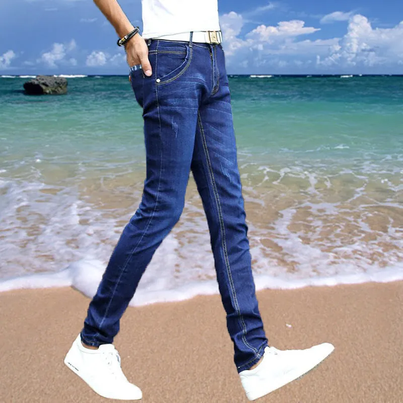 Thin men's loose skinny casual jeans in pure black with low waist, cropped leg, small leg opening, and zip fly.