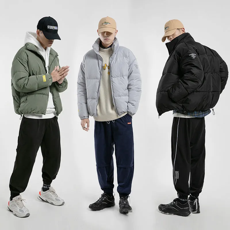 Men's stand collar padded jacket in black, polyester filling, zipper front, side slit pockets, straight hem, loose fit
