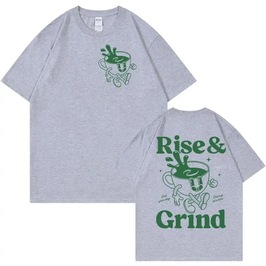 Man wearing a loose black linen t-shirt with a green 'Rise And Grind Green Coffee' cartoon graphic print.