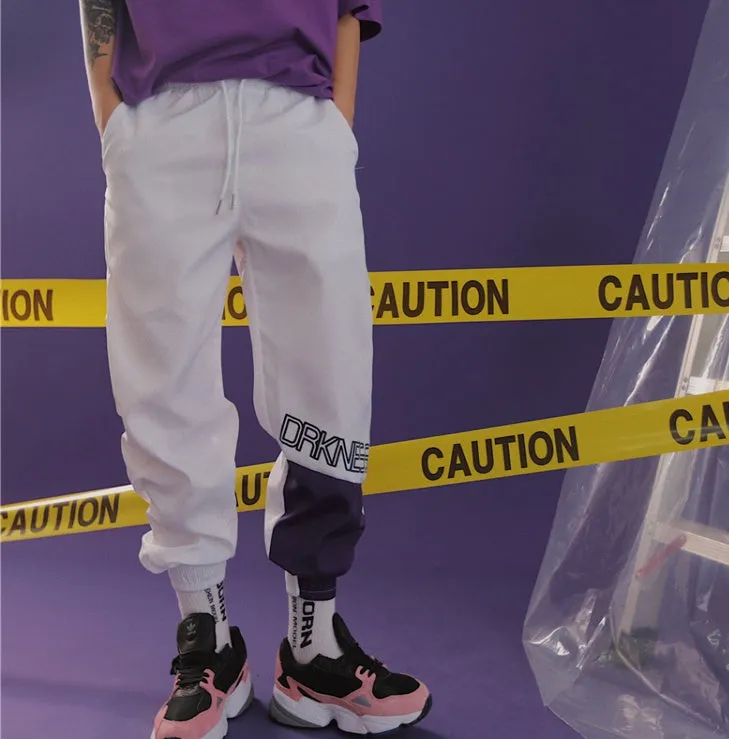 Green Japanese hip hop sweatpants with hit colour stitching, letter print, and bouquet floral design on a low-waist drawstring style