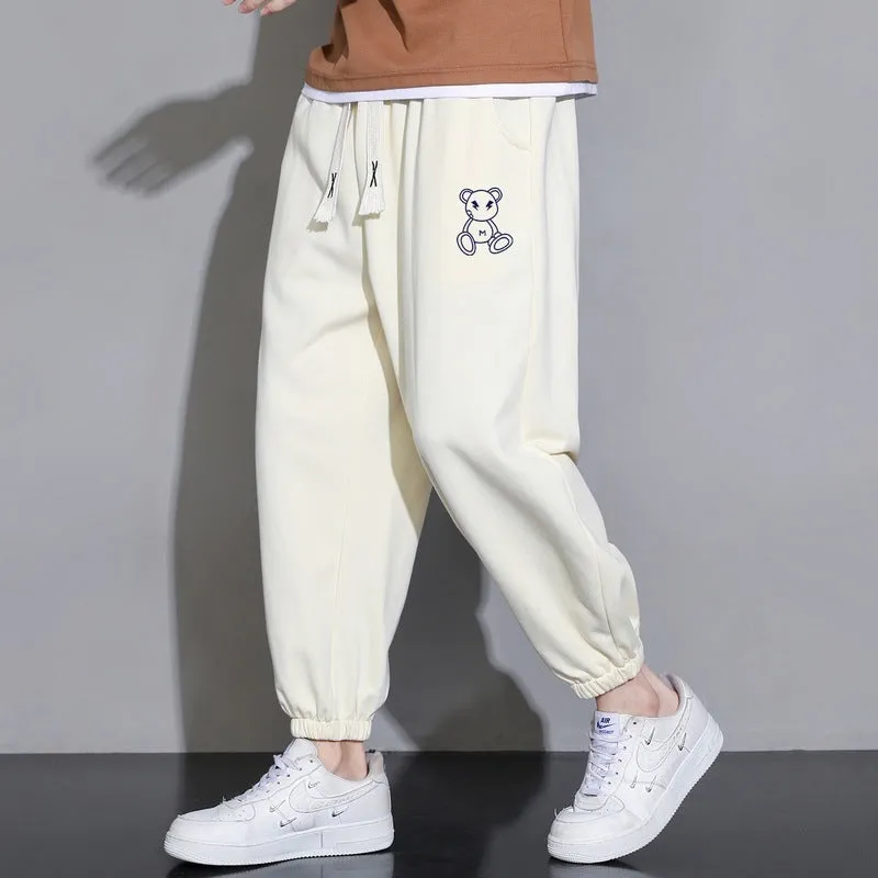Men's cropped casual loose tapered pants in black, 100% polyester, mid waist, cropped length, sizes M to 4XL.