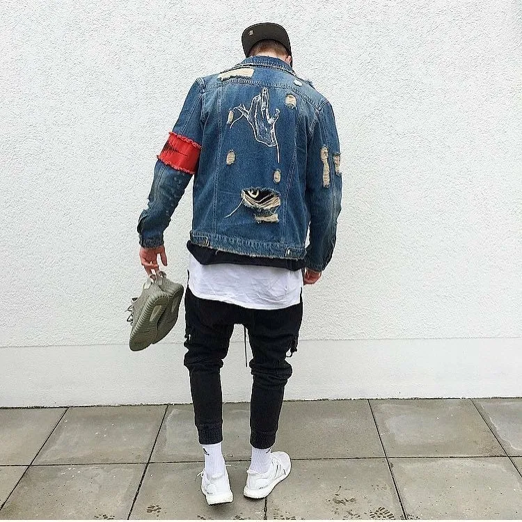 Blue embroidered cotton denim jacket for women on model, showing decorative stitching on front panels