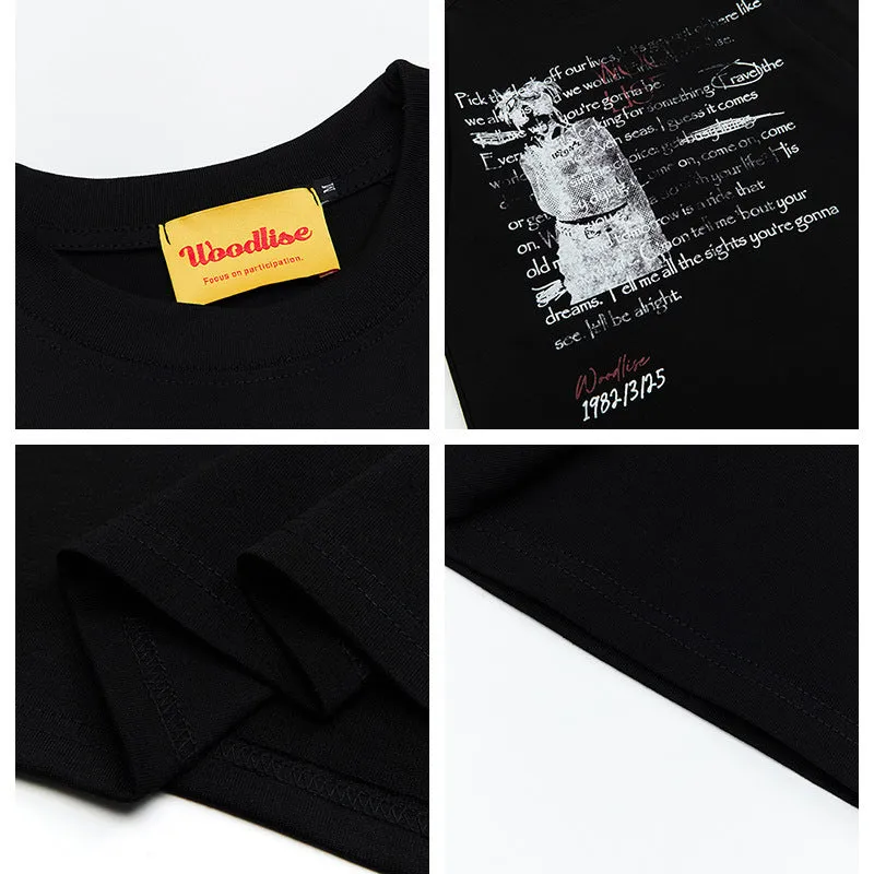 Men's black retro loose fit cotton t-shirt with white printed letters and raglan sleeves.
