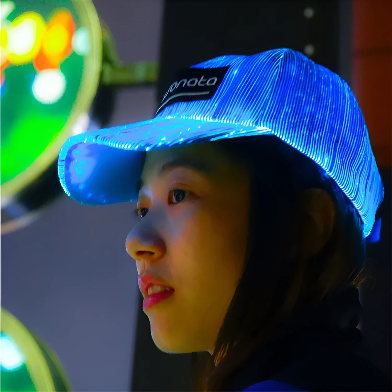 White unisex luminous baseball cap with fiber optic fabric LED glow against dark background