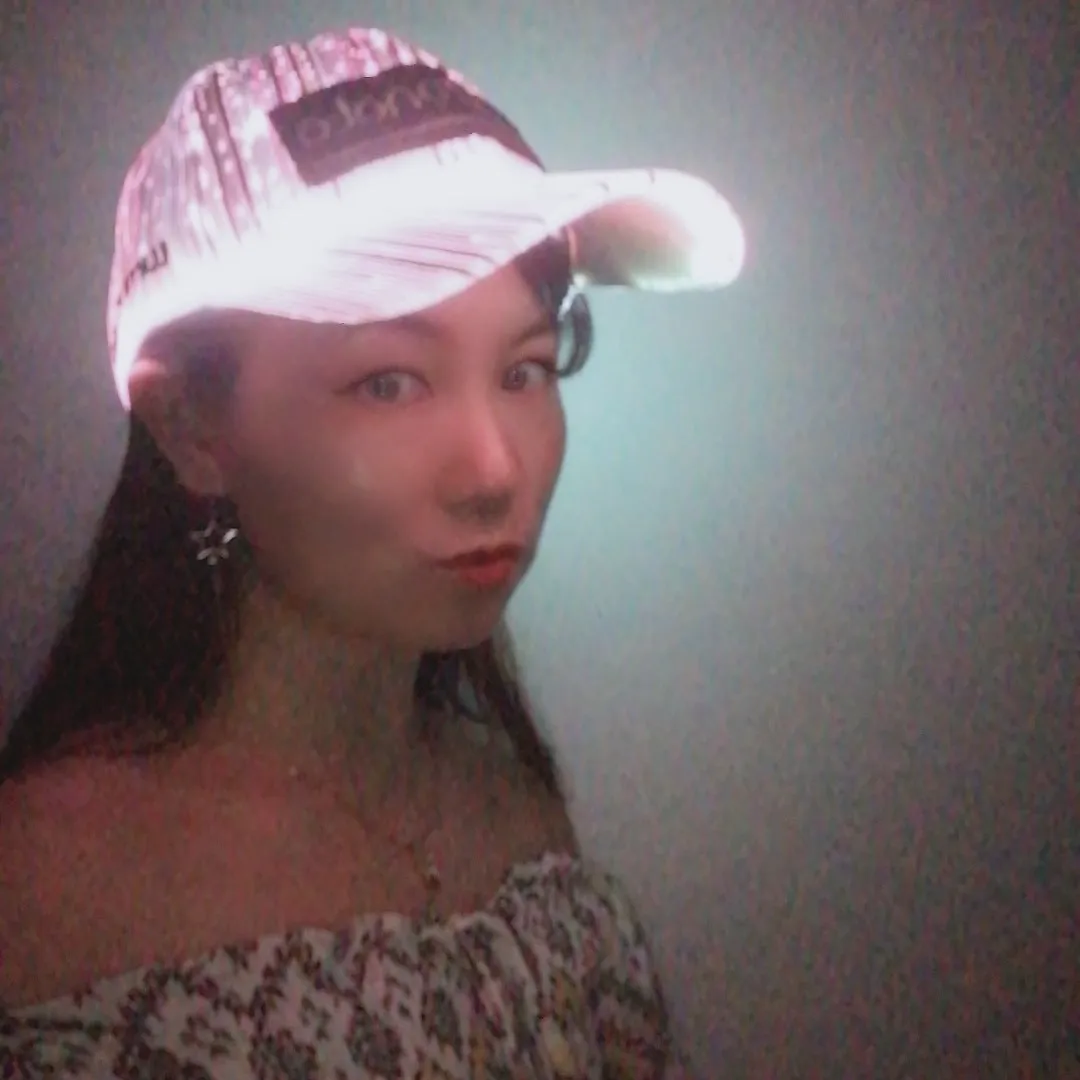 White unisex luminous baseball cap with fiber optic fabric LED glow against dark background