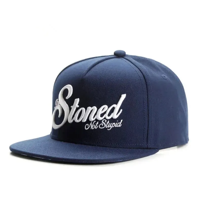 Navy blue cotton baseball cap with machine-embroidered English letters on front, dome crown, adjustable back strap