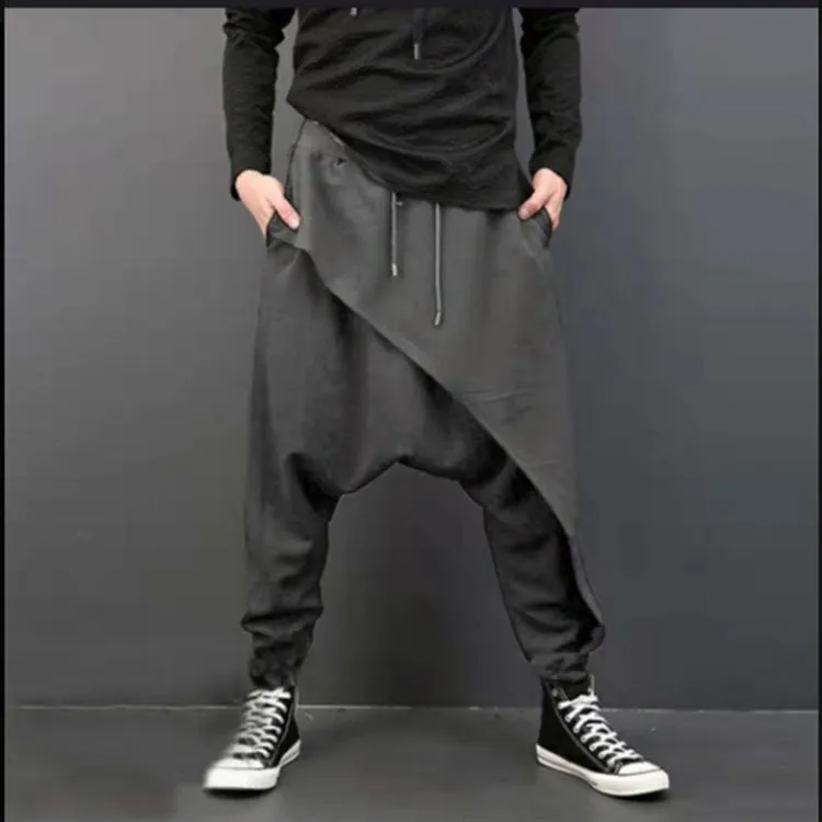 Cotton loose harem pants in black with elastic waist, side view on model