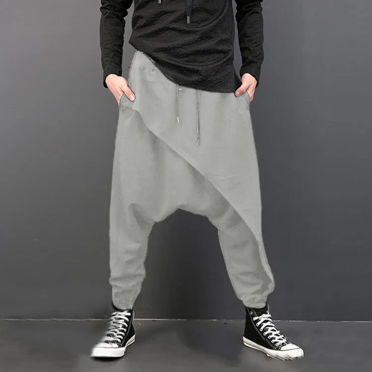 Cotton loose harem pants in black with elastic waist, side view on model