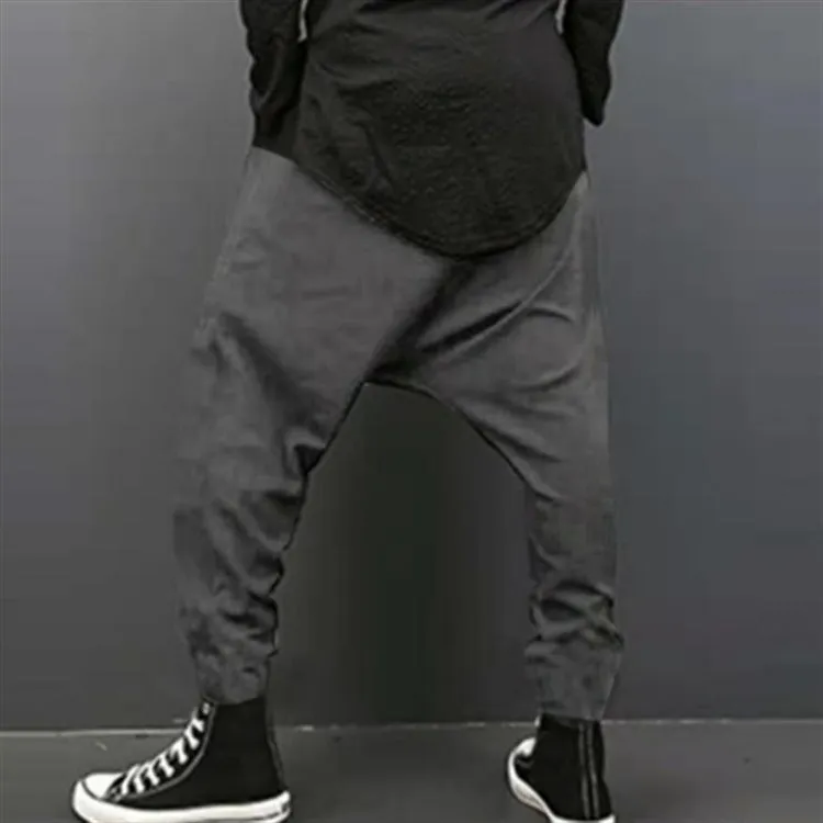 Cotton loose harem pants in black with elastic waist, side view on model