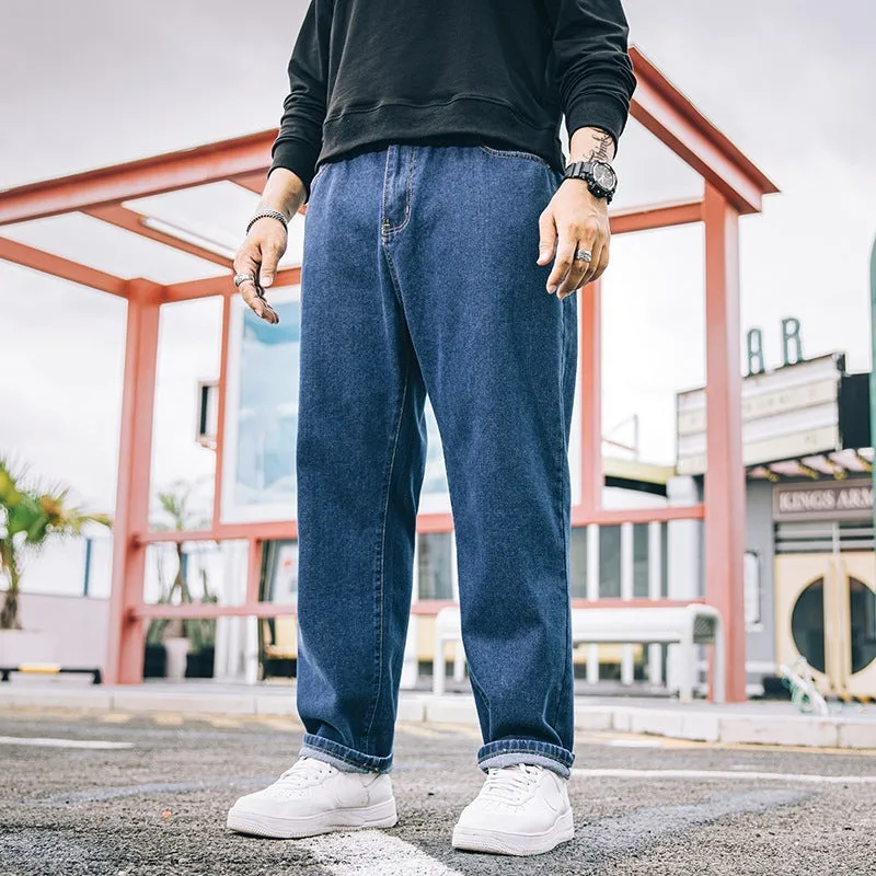 Men's dark blue loose straight-leg casual jeans on a hanger, showing mid-waist and zipper fly.