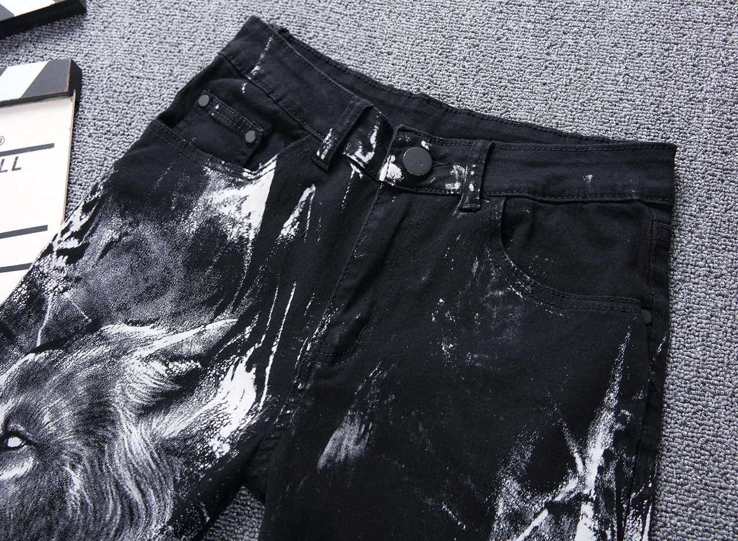Men's black wolf print jeans with realistic wolf head design on cotton denim fabric