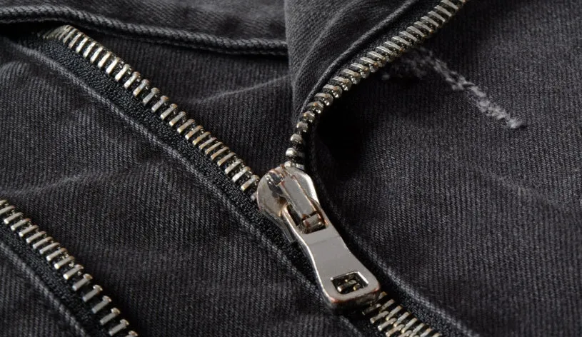 Black slim fit linen denim jacket with zipper front, zipper pockets, and lapel collar on a person