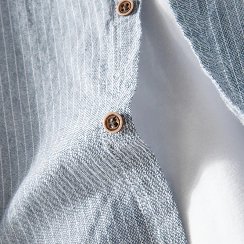 White long sleeve cotton shirt with classic fit, collared neckline, and button front