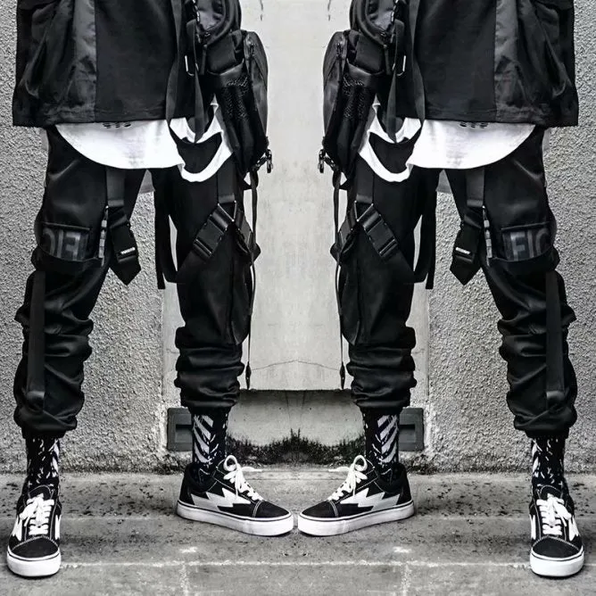 Black functional overalls for men with loose paratrooper-style fit and straight trousers, front view