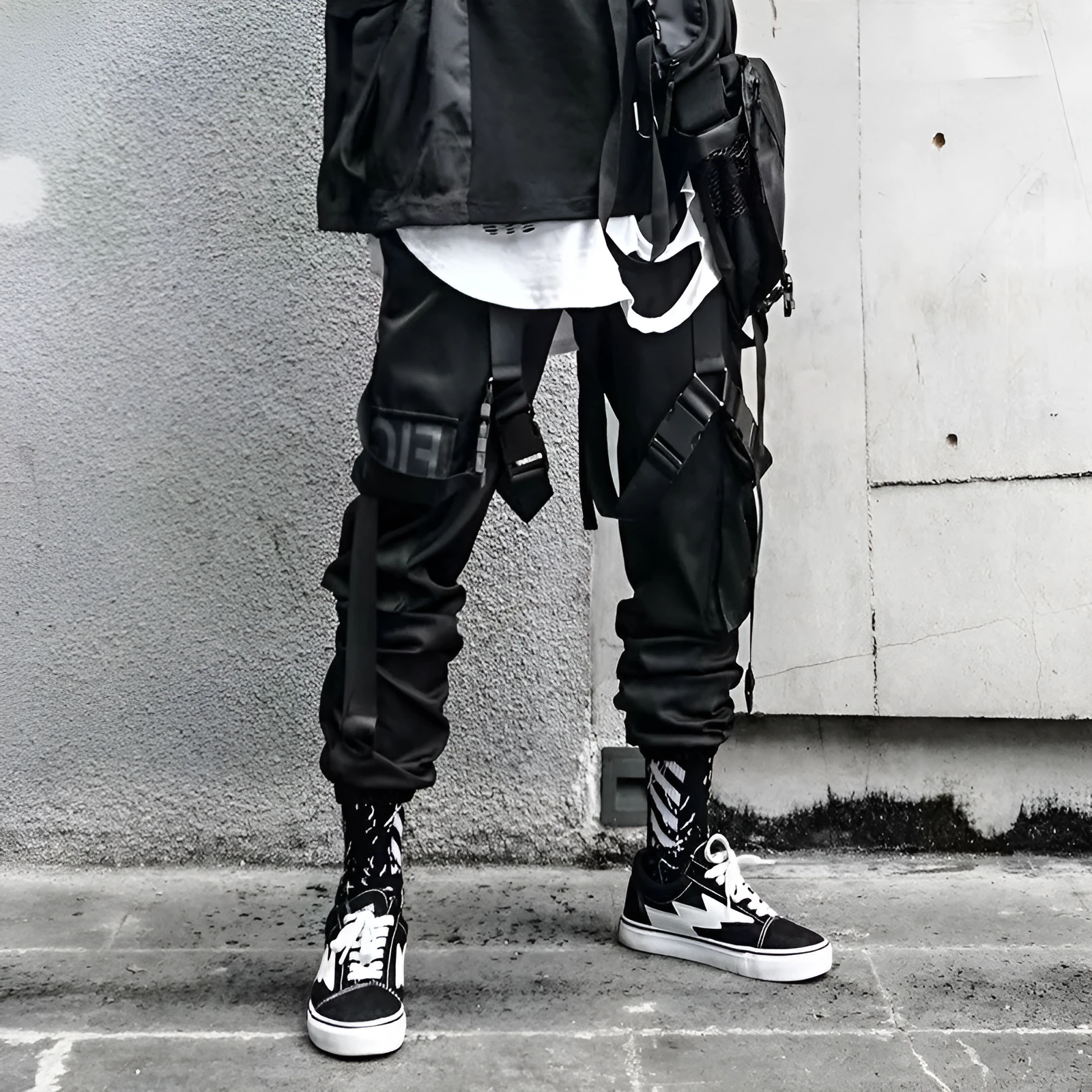 Black functional overalls for men with loose paratrooper-style fit and straight trousers, front view
