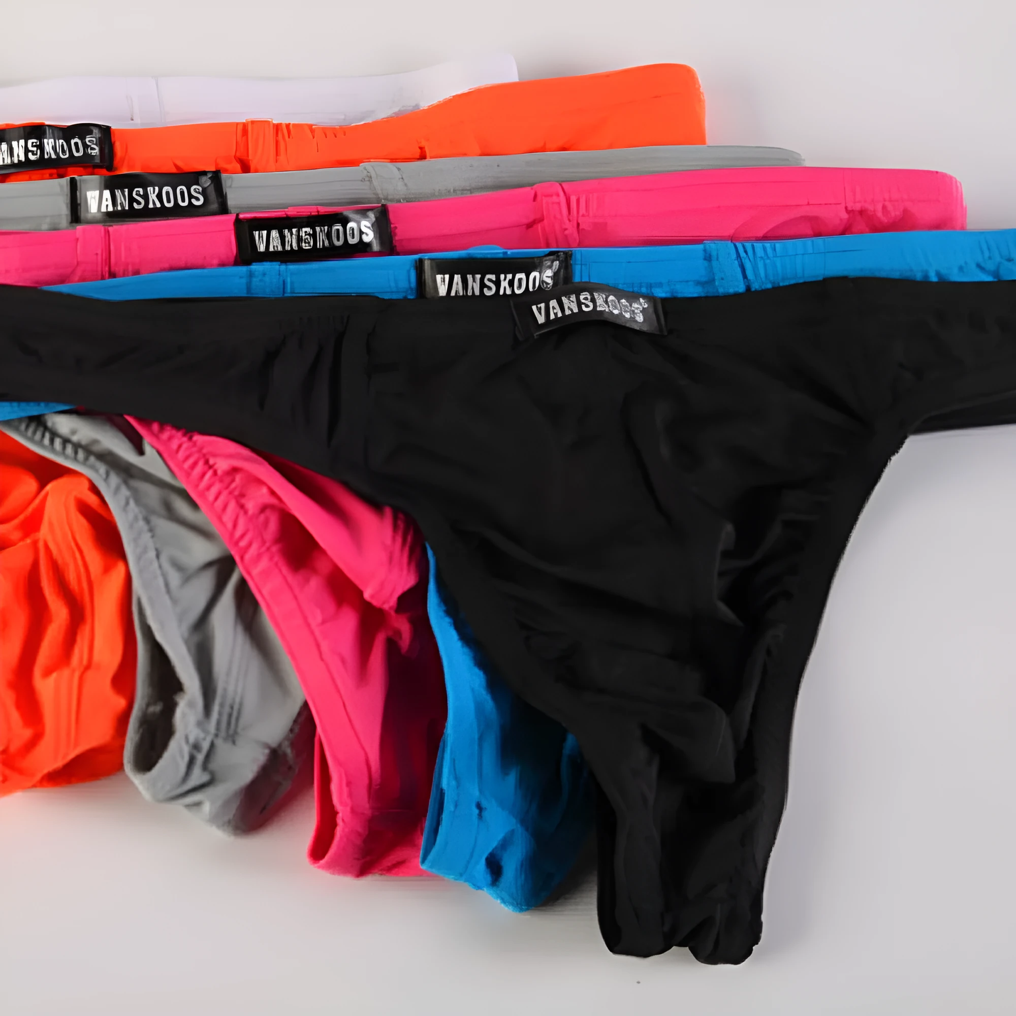 Men's low waist T-shaped bikini swimming trunks in solid colour nylon fabric, front view.