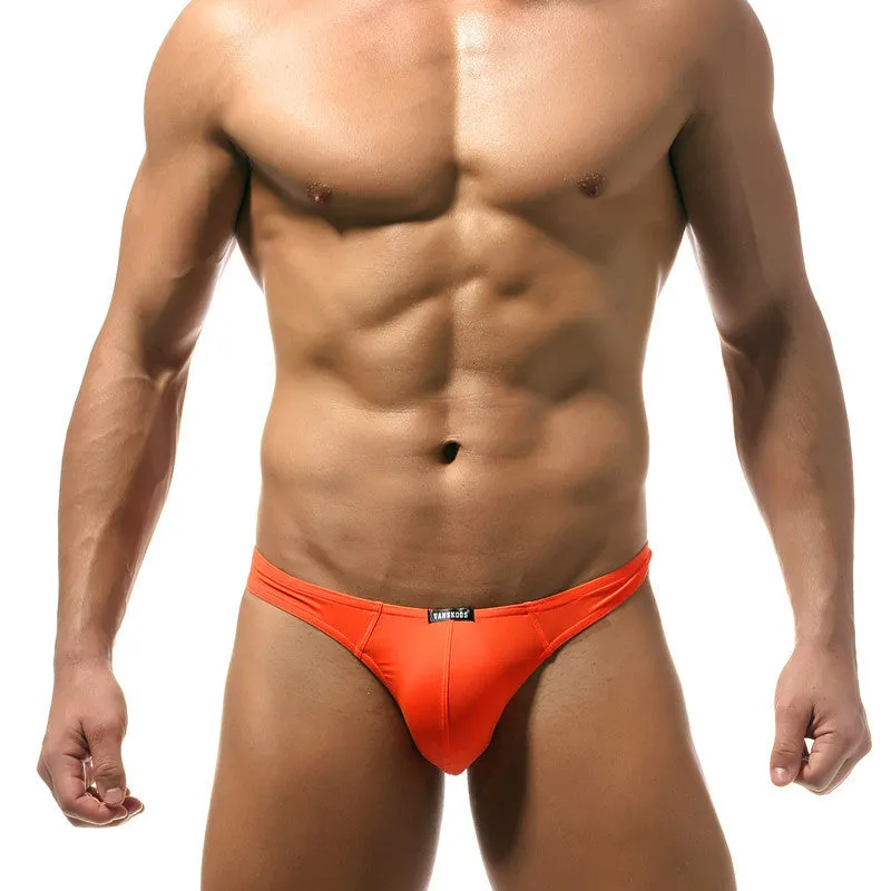 Men's low waist T-shaped bikini swimming trunks in solid colour nylon fabric, front view.