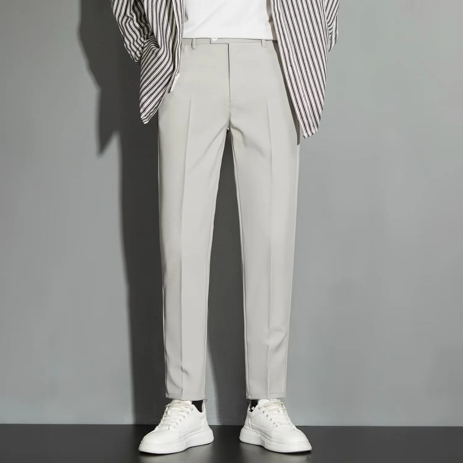 Men's straight cut ankle-length trousers in draping fabric showing apricot colour option