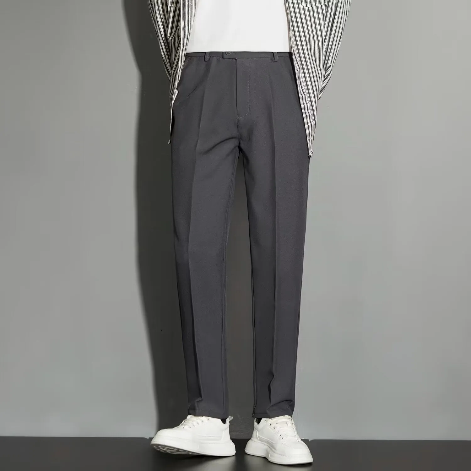 Men's straight cut ankle-length trousers in draping fabric showing apricot colour option