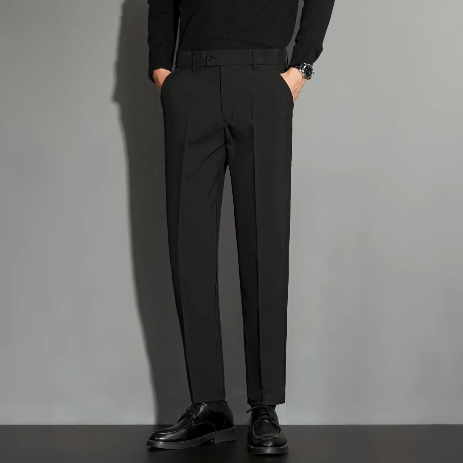 Men's straight cut ankle-length trousers in draping fabric showing apricot colour option