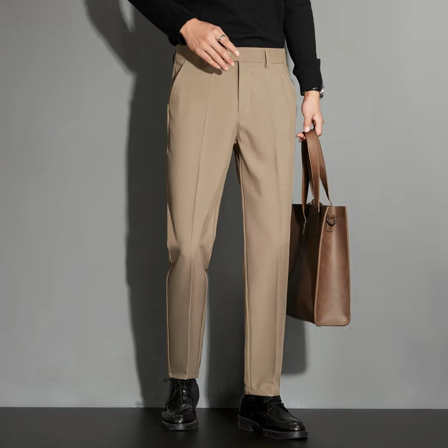 Men's straight cut ankle-length trousers in draping fabric showing apricot colour option