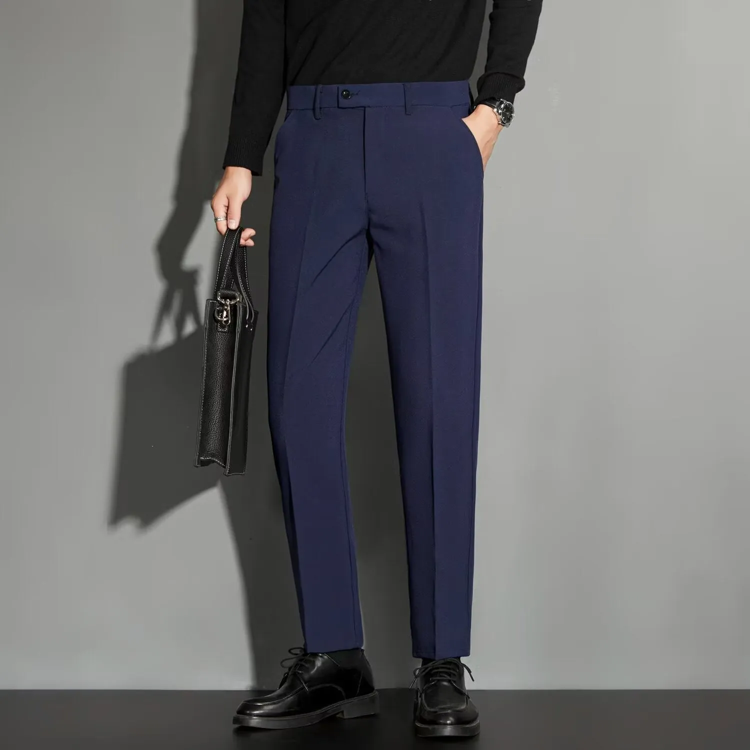 Men's straight cut ankle-length trousers in draping fabric showing apricot colour option