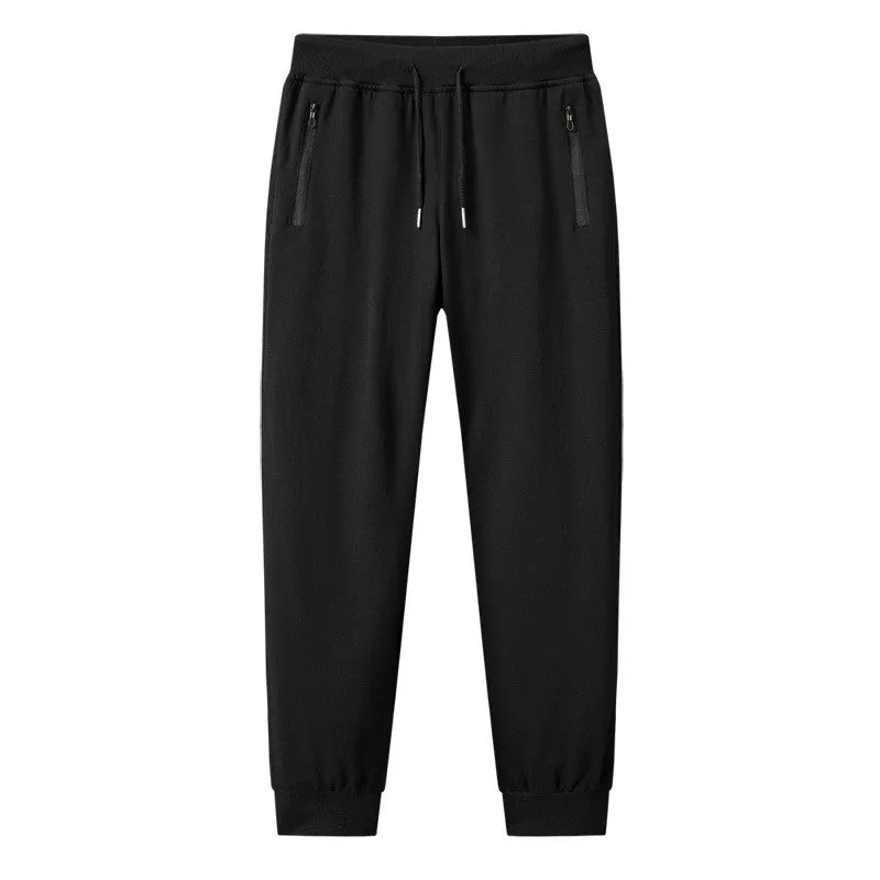 Men's thin leisure tapered knitted pants in black with ankle tie, standing on a neutral background